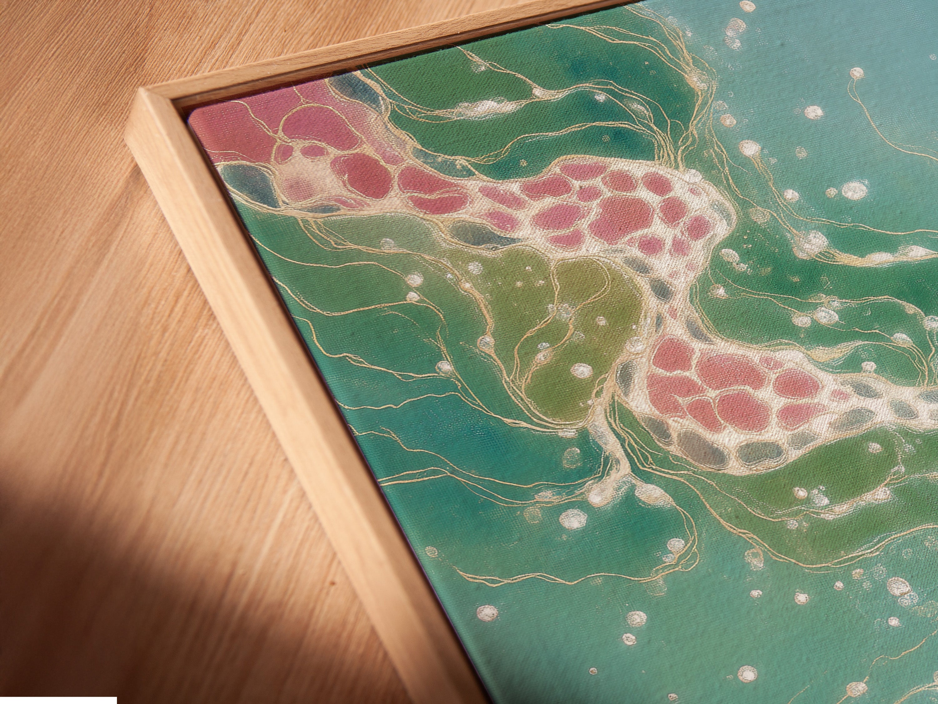 Close-up of a canvas print in a floating frame. The abstract artwork shows teal and pink hues. The flowing wall decor enhances any room. Perfect for contemporary art lovers.