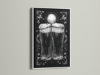 A framed artwork is on display. The art is in a white frame. The artwork features a monochromatic illustration of two beer glasses. The beer glasses are the focal point.  The print adds a touch of elegance to any room. The white frame provides a clean look.
