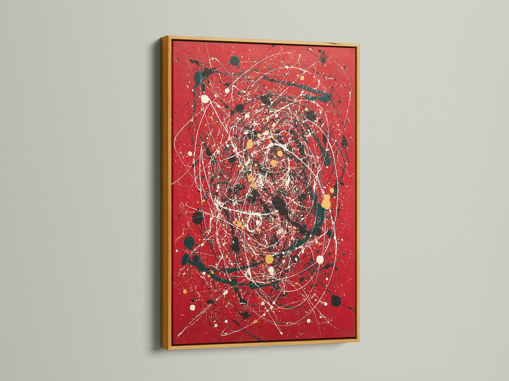 Vibrant abstract splatter art print displayed on a red canvas. The artwork is showcased in a luxurious gold frame. Modern paint drip techniques enhance its contemporary appeal. This bold red art adds sophistication to any interior. Perfect for those seeking expressive modern artwork.