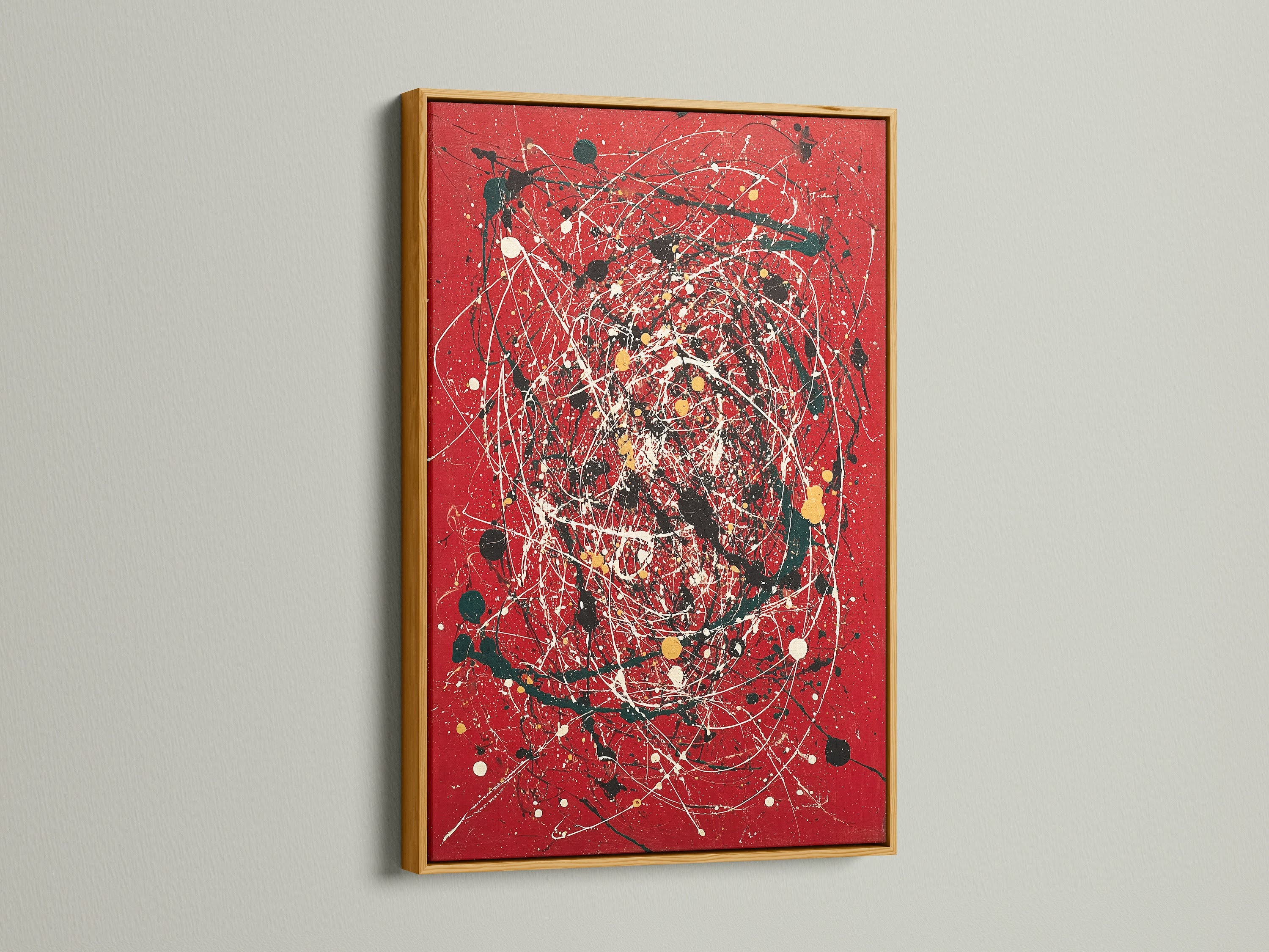 Vibrant abstract splatter art print displayed on a red canvas. The artwork is showcased in a luxurious gold frame. Modern paint drip techniques enhance its contemporary appeal. This bold red art adds sophistication to any interior. Perfect for those seeking expressive modern artwork.