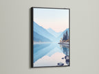 Black frame displays a beautiful mountain lake artwork. The serene nature landscape photography brings a calming effect. The pastel blue wall art enhances any room. It is ideal for bedroom wall decor. The nature canvas print creates a peaceful mountain view. Complements modern spaces.