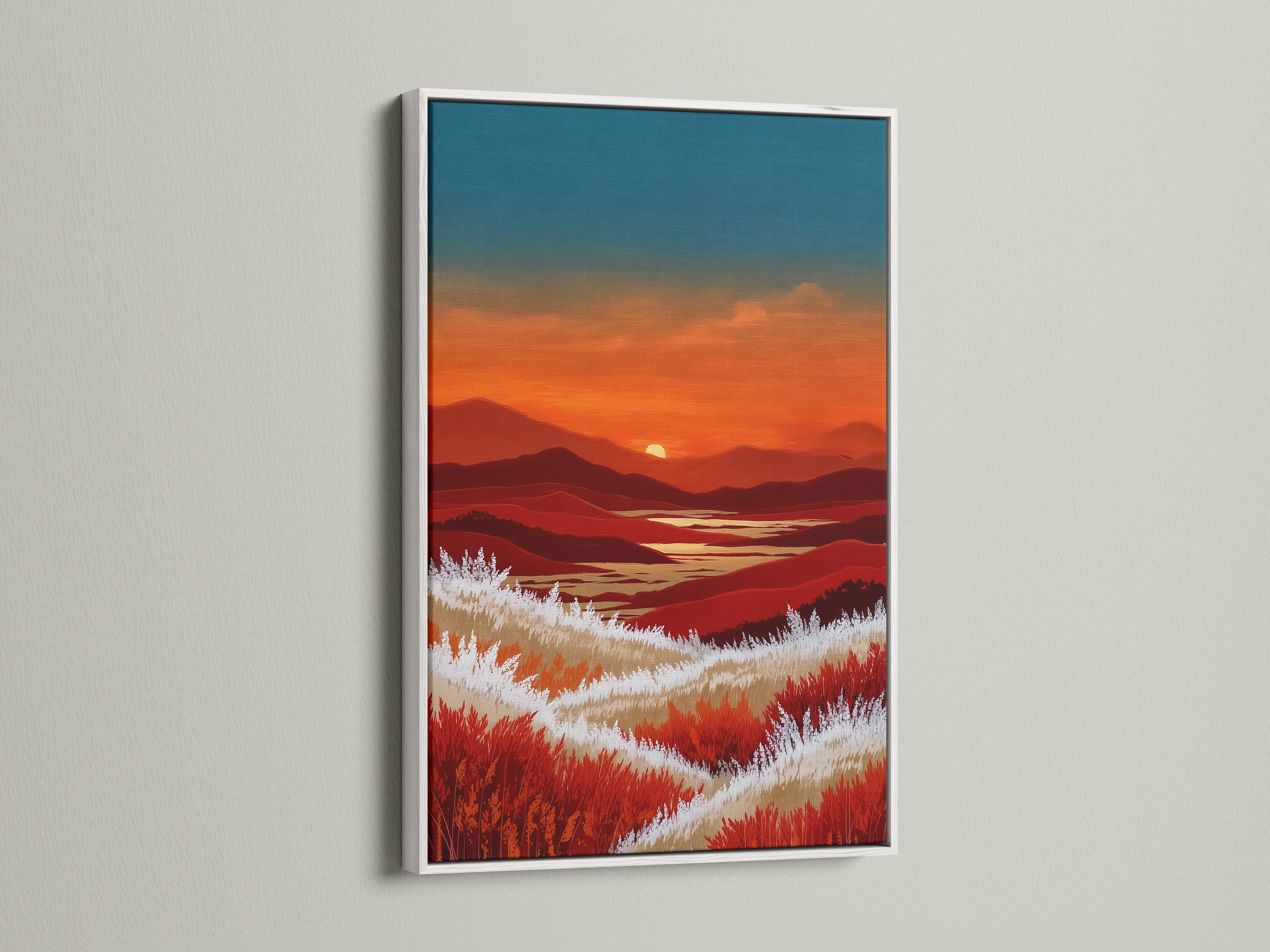 This mountain sunset artwork is framed in white. The white frame offers a clean and contemporary look. The warm orange and teal colors of the artwork pop against the white backdrop. It's a great piece for adding a touch of nature to your living room or bedroom. This piece offers rustic elegance.