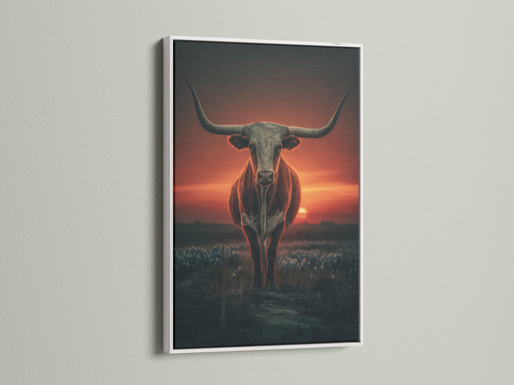 Longhorn bull artwork displayed in a white frame. This western wall art features a beautiful sunset. It brings a touch of country charm to any space. The white frame enhances the dramatic animal photography. Perfect for rustic home decor.