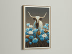 Longhorn bull artwork with blue wildflowers. The frame is oak. Western wall decor is perfect for any room. This bull canvas print is ideal for modern farmhouse decor. A blue floral art piece for your home.