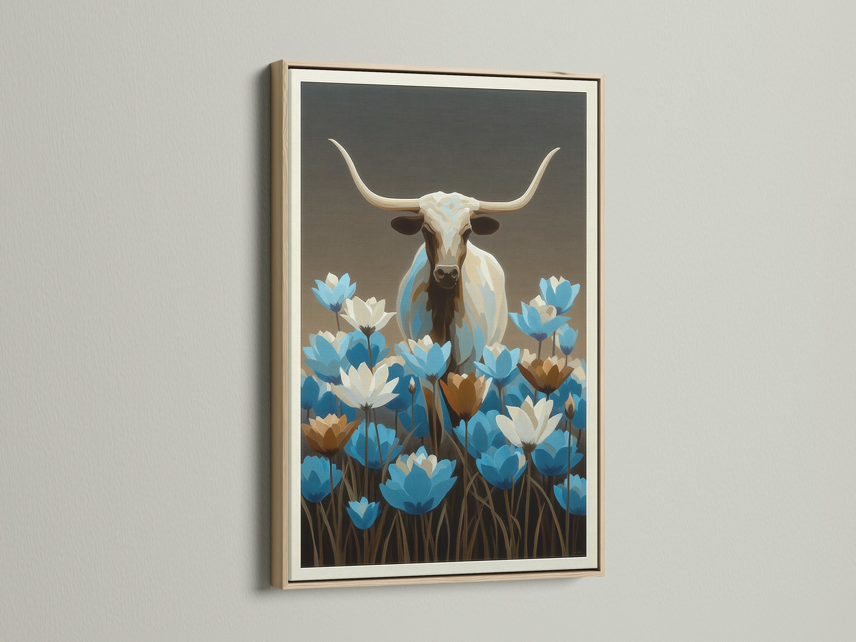 Longhorn bull artwork with blue wildflowers. The frame is oak. Western wall decor is perfect for any room. This bull canvas print is ideal for modern farmhouse decor. A blue floral art piece for your home.