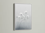 Elevate your space with minimalist flower art in a white frame. The botanical print features soft gray and white hues. This modern canvas art is perfect for bedroom wall decor. White frames create a clean contemporary look for delicate flower artwork.