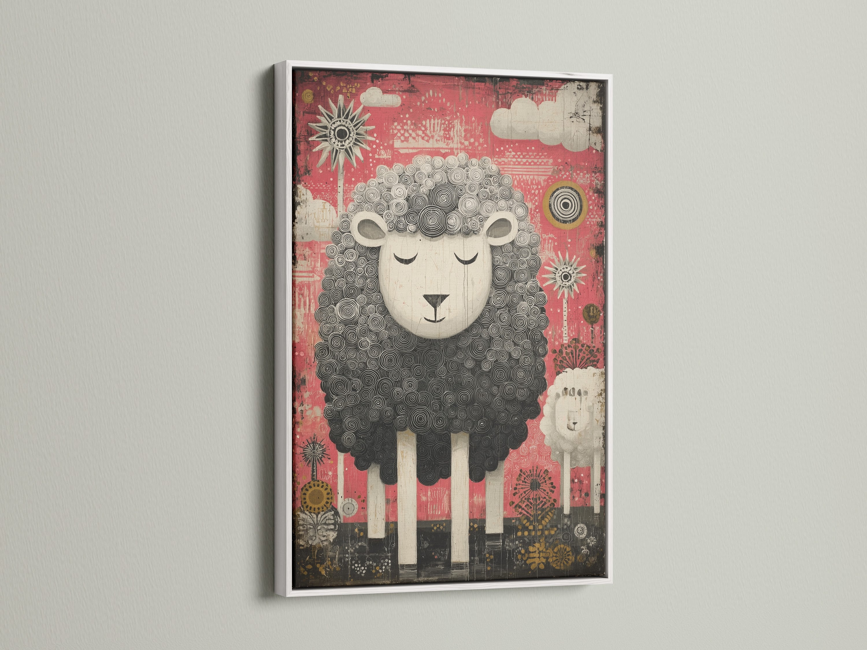 White frame displays a cute sheep artwork. The artwork features a black and white sheep. The sheep is set against a pink backdrop. Clouds and suns decorate the background. The white frame offers a clean modern look.