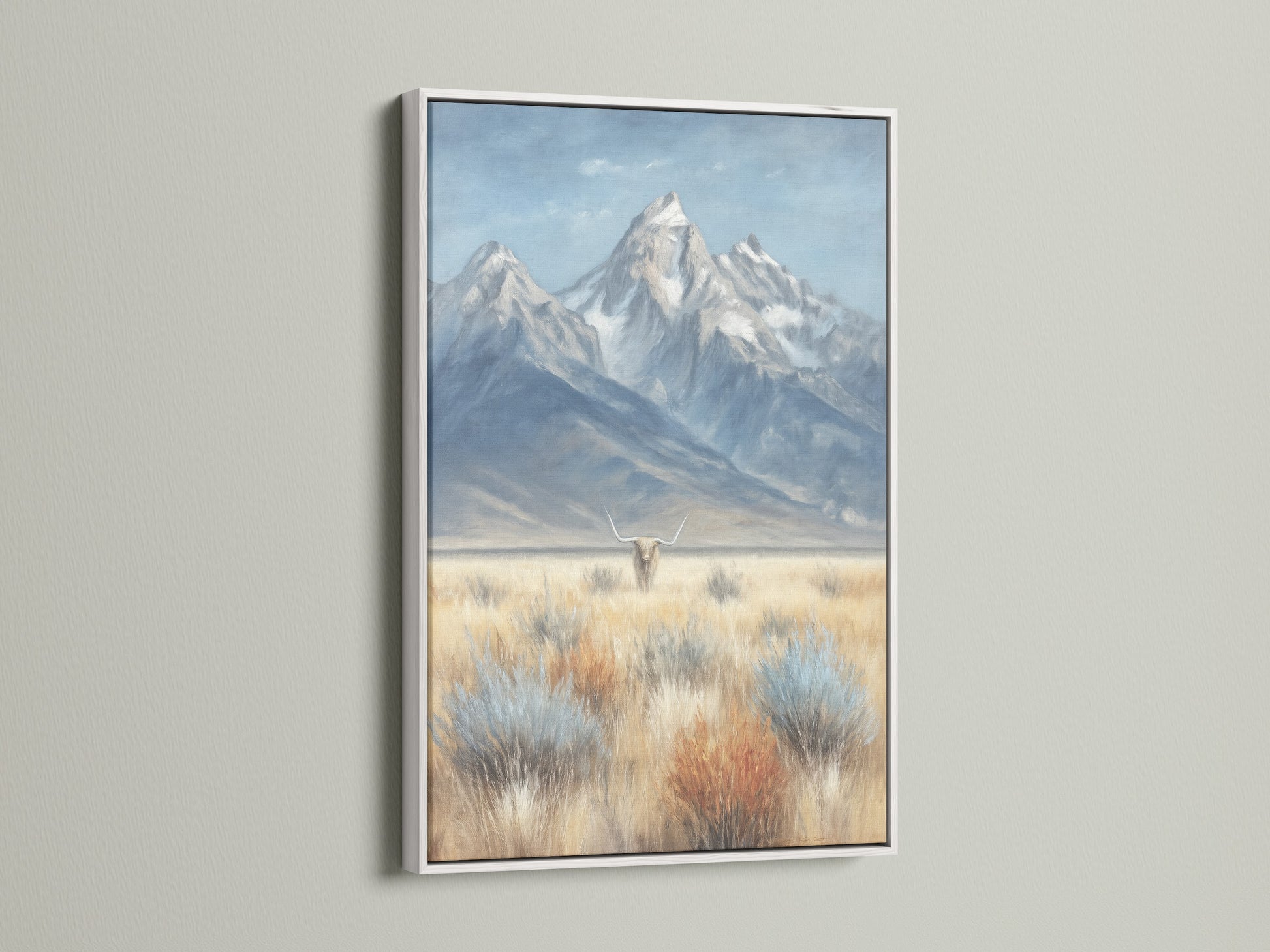 This mountain and highland cattle artwork is elegantly framed in white. The white frame contrasts beautifully against the neutral wall. This countryside art evokes a farmhouse feel. It’s ideal for adding a touch of rustic home decor to your living room or office.