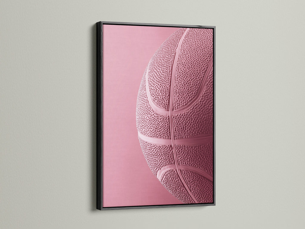 Black frame on a wall. The black frame features a pink basketball art print. A black frame adds a touch of sophistication to any artwork. Its ideal for creating a bold statement in your space. Explore the impact of framed art.