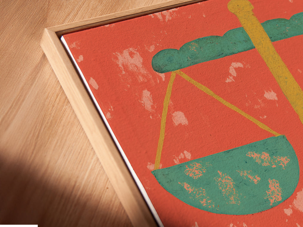 A close-up angled view of the Justice Scales Canvas Print in a floating frame. The artwork enhances any room. It is great for legal offices home offices and libraries. This vintage-style legal artwork is a great gift for attorneys. The orange and green colors add a stylish touch.