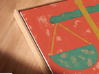 A close-up angled view of the Justice Scales Canvas Print in a floating frame. The artwork enhances any room. It is great for legal offices home offices and libraries. This vintage-style legal artwork is a great gift for attorneys. The orange and green colors add a stylish touch.