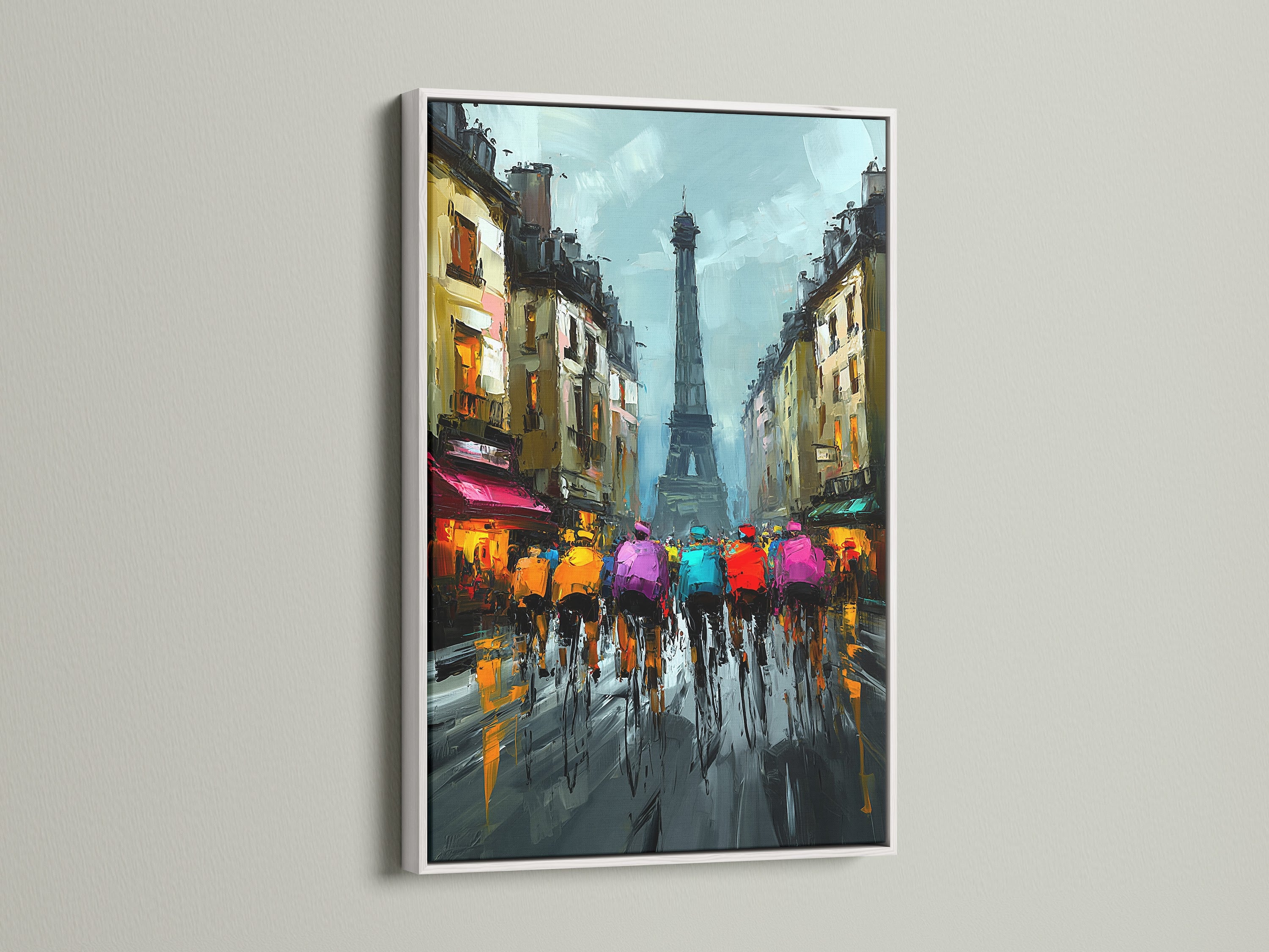 Artwork featuring cyclists in Paris with the Eiffel Tower in a white frame. The bright white frame makes the artwork pop. This piece adds a modern touch to any space. The artwork is a stunning focal point for home or office. Perfect for contemporary decor.