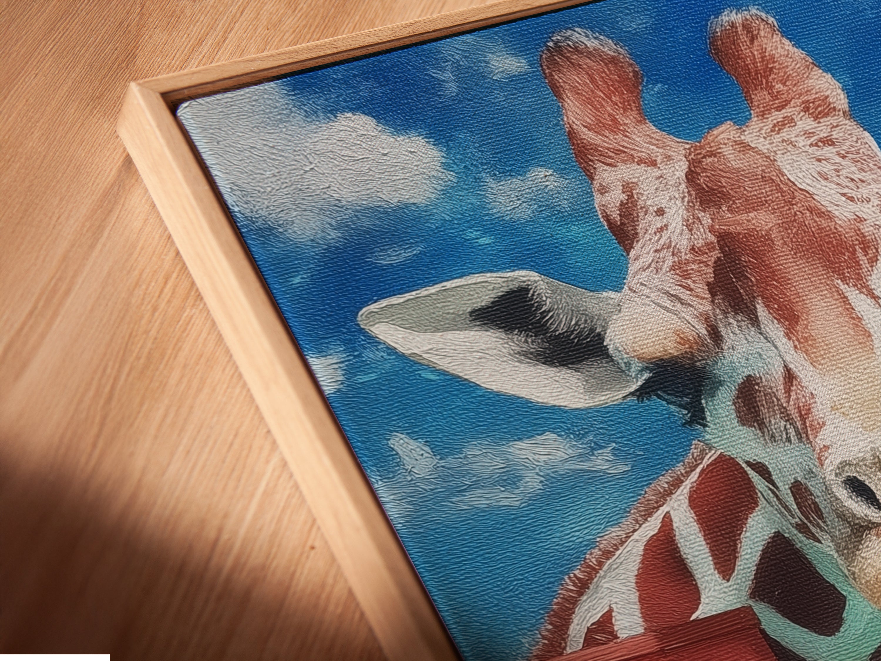 A close-up angled view reveals a canvas print of the giraffe artwork in a floating frame. The cityscape print adds depth and character. This animal canvas art creates a modern and playful look. The floating frame enhances the artwork's visual appeal. Perfect for kids room decor.