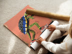 A woman is carefully rolling a fine art poster paper. The turtle skateboard art print is being prepared. This ensures the playful animal artwork arrives in perfect condition. Fine art paper enhances the colors and details. Get ready to add this cool piece to your wall art collection.