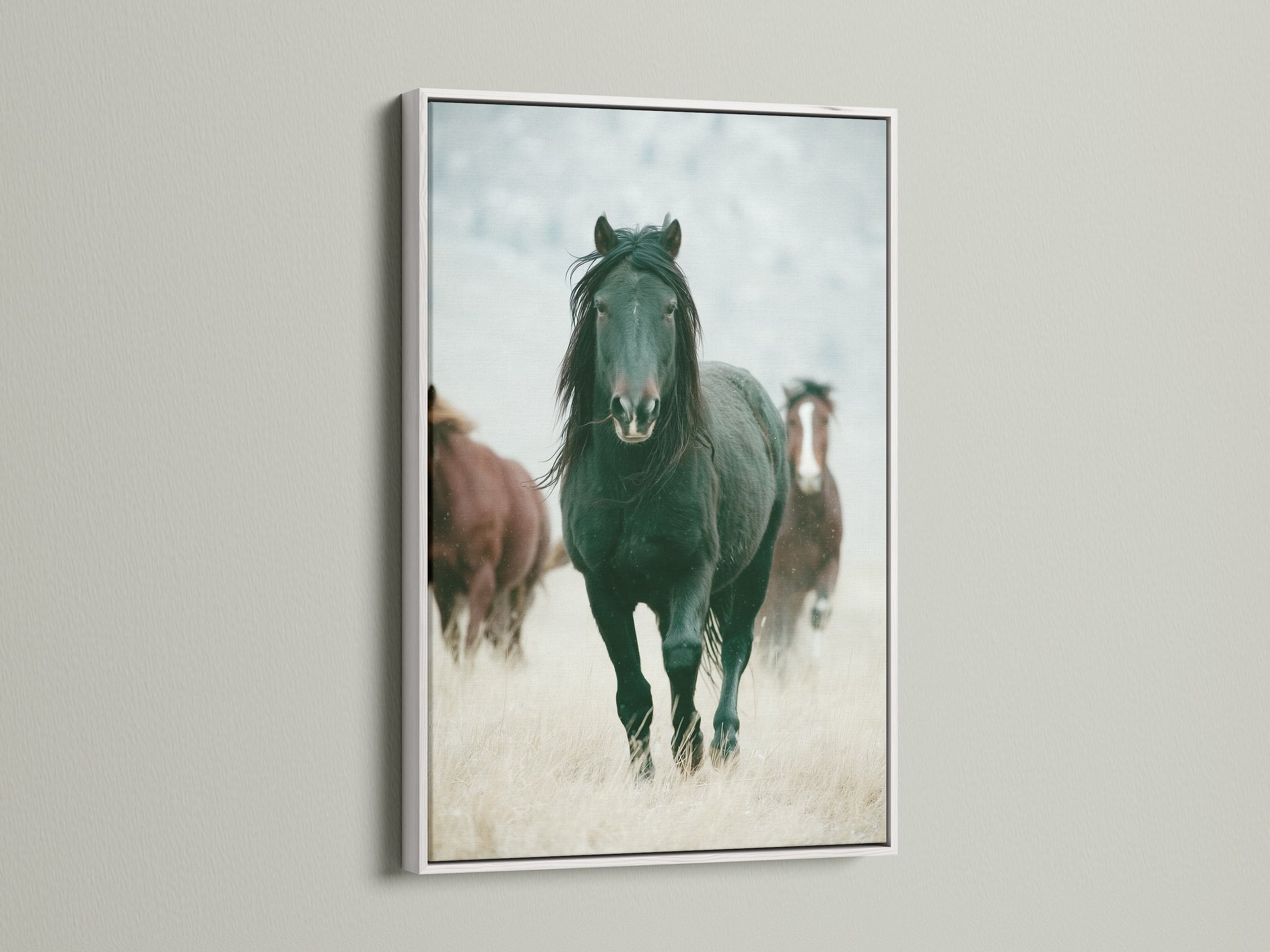 Wild horses artwork in a white frame. This rustic artwork adds a touch of the Wild West to any room. Perfect for living rooms bedrooms or offices seeking a country or farmhouse style. This artwork is great for ranchers or anyone that appreciates wildlife art. The white frame complements any color scheme.