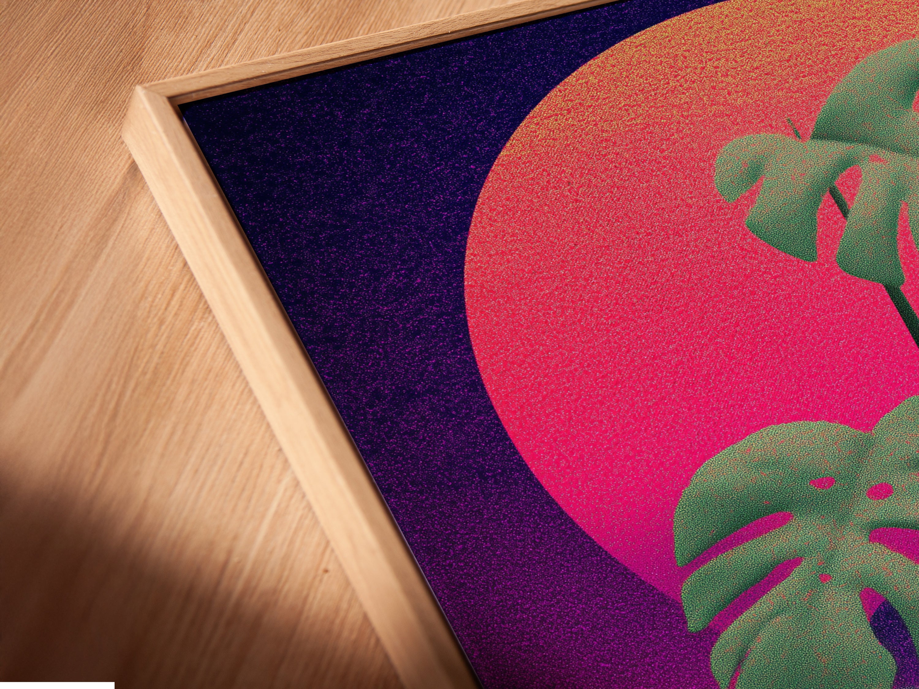 A close-up angled view of a canvas print. The monstera artwork is showcased in a floating frame. The floating frame enhances the artwork's depth. It adds a contemporary touch to any space.