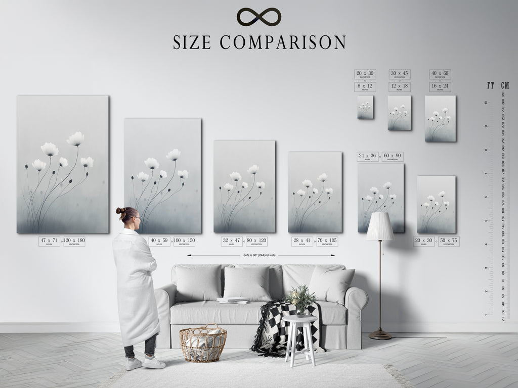 A size comparison chart in an interior setting is displayed. See how minimalist flower artwork fits your space. The soft gray and white botanical print looks great in any size. Choose the perfect dimensions for your modern canvas art. Visualize delicate flower artwork in your home.