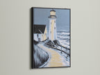 Lighthouse coastal artwork in a black frame. This nautical artwork adds a modern touch to any wall. The black frame creates a bold statement. Consider it for living rooms bedrooms or beach houses.