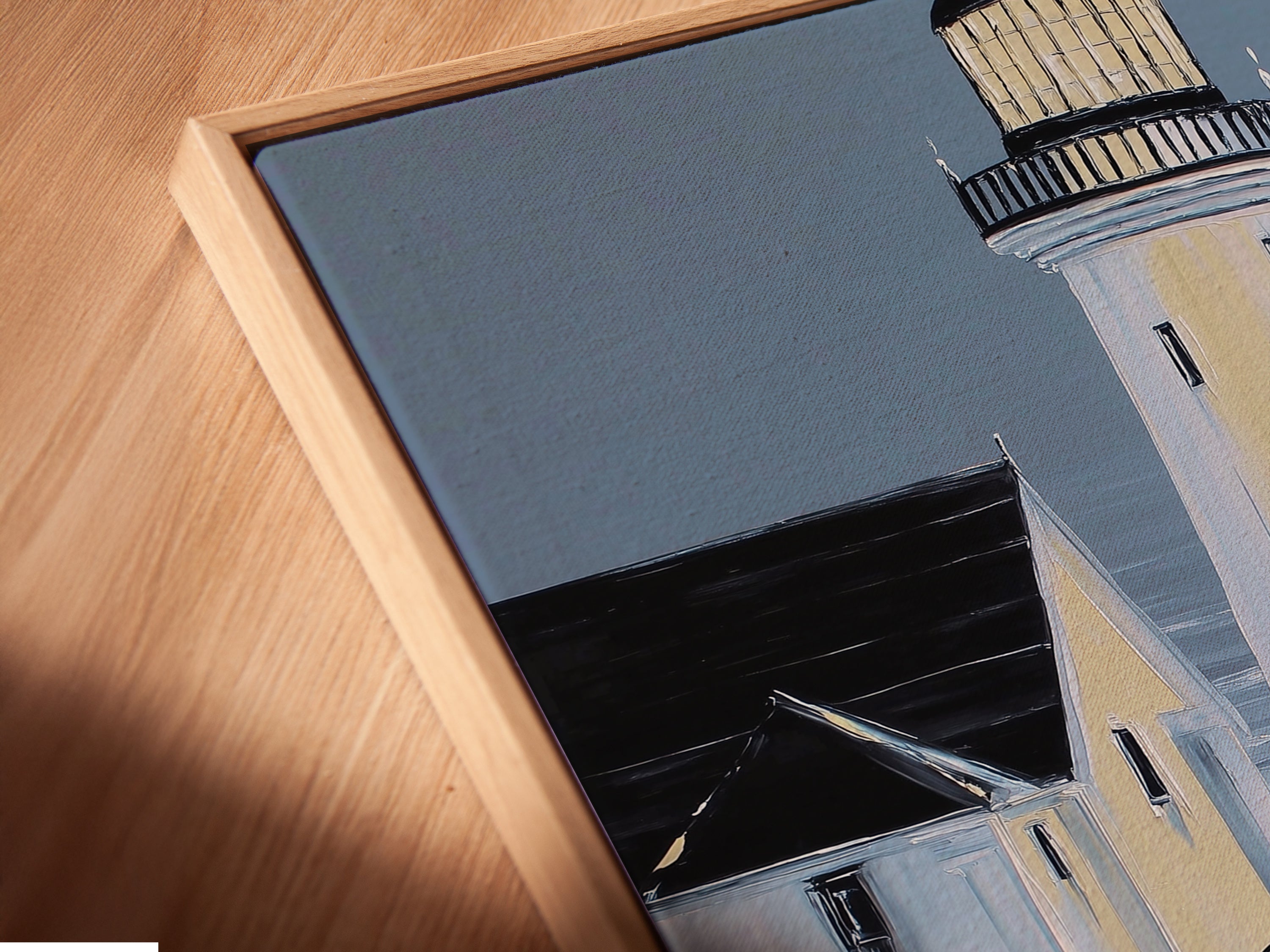 Angled close up of a canvas print in a floating frame. This lighthouse artwork is perfect for home or office. The floating frame adds depth and sophistication. It is an ideal choice for interior designers.