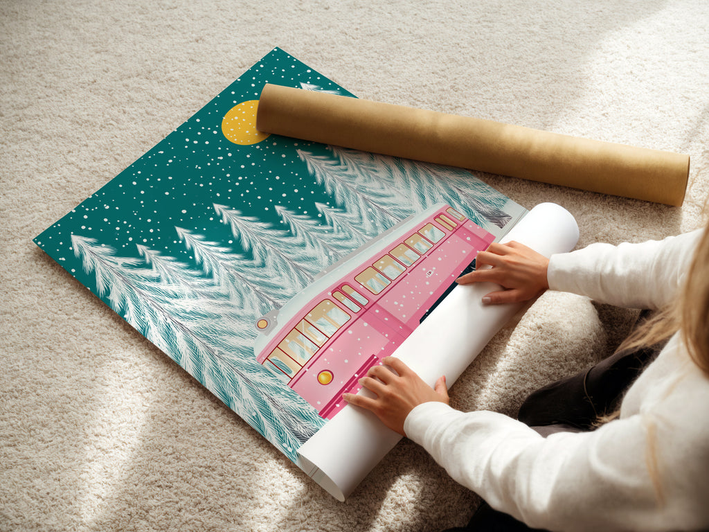A woman is carefully rolling a fine art poster paper. This paper will be used to create beautiful prints of the winter tram artwork. The pink train and snowy forest will come to life. Order your own high-quality print today for holiday decor.