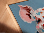 A close-up angled view showcases a canvas print in a floating frame. The pig art features a colorful farm animal with a cigar. The floating frame enhances the artwork's contemporary appeal. This whimsical piece adds a modern touch to any space. It's perfect for those seeking unique and stylish decor.