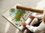 A woman is carefully rolling a fine art poster paper featuring the Spanish Courtyard artwork. The artwork includes a white building with a blue dome and an orange tree. Fine art poster paper ensures high-quality reproduction. Perfect for collectors and art enthusiasts.