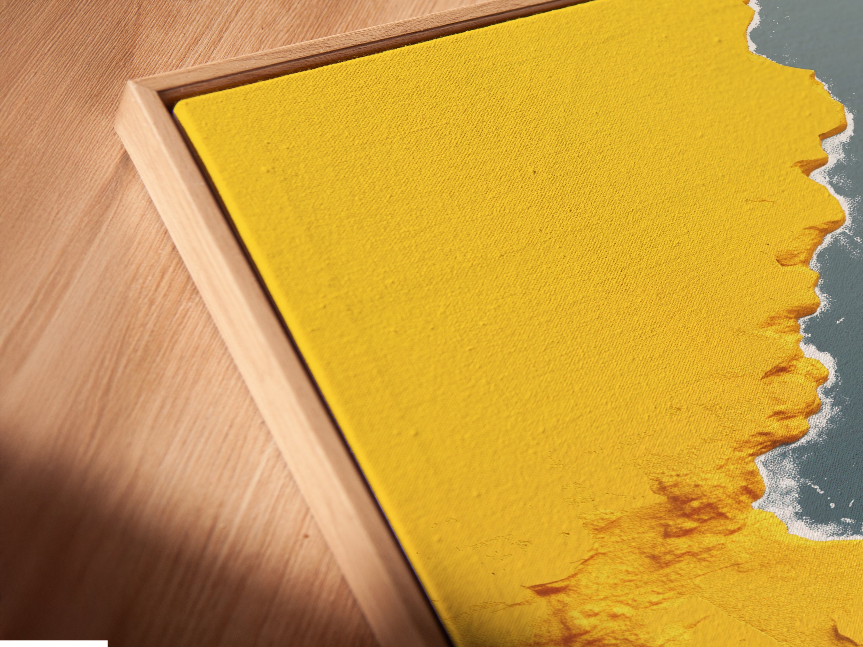 A close-up reveals a canvas print in a floating frame. The abstract gold river artwork is modern and stylish. This teal wall art is perfect for contemporary spaces. See the detail in this elegant floating frame artwork.