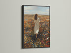 Black frame artwork against a white wall. The art shows a woman in a white dress. She walks through a vibrant field of flowers. The black frame adds a touch of sophistication. It makes the colors pop. Discover framed art that suits your style. Enhance your home decor with framed artwork.