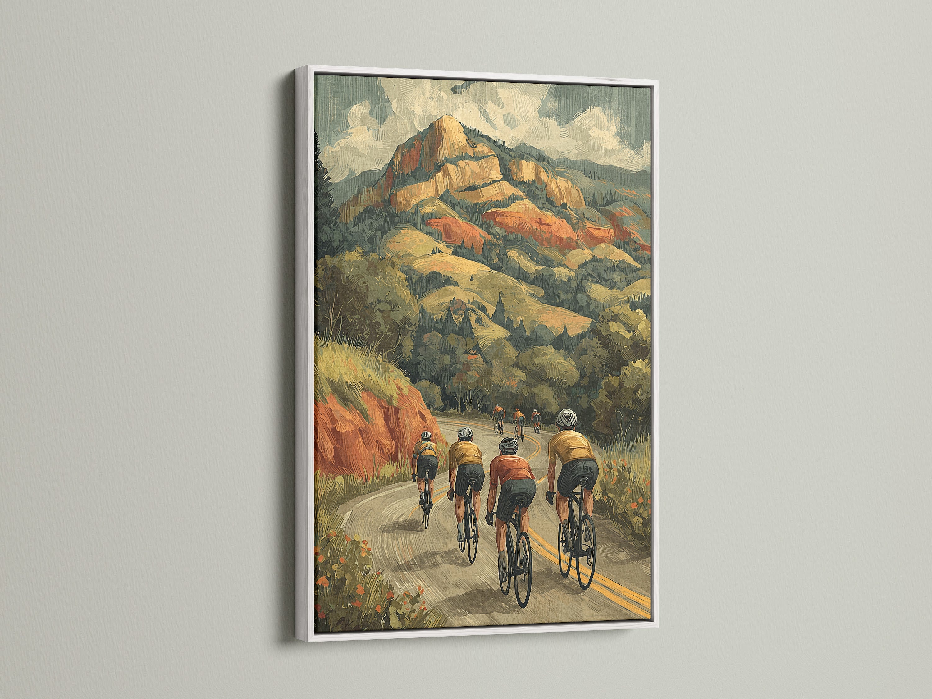 Cycling wall art with a white frame. This artwork captures cyclists on a scenic mountain route. A retro sports canvas art print. It complements any room with a clean and modern look. Shop cycling decor now for a stylish update