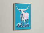 This is a longhorn cow artwork. The art is framed with oak. The artwork features a turquoise background. A cow with pink spots stands out. This piece enhances any rustic or bohemian space. It is ideal for adding a touch of western charm.