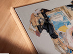 Close-up angled view of a canvas print in a floating frame. Dog portrait art shown in detail. The mixed media print highlights the texture. This quirky animal canvas art is perfect for unique office decor. A modern touch for any space.