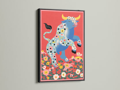 Floral Bull artwork in a black frame. This animal artwork brings an eclectic touch to studios and boutiques. The black frame provides a modern contrast to the folk art print. The flower bull is set against a colorful backdrop. Great for adding character to creative spaces.
