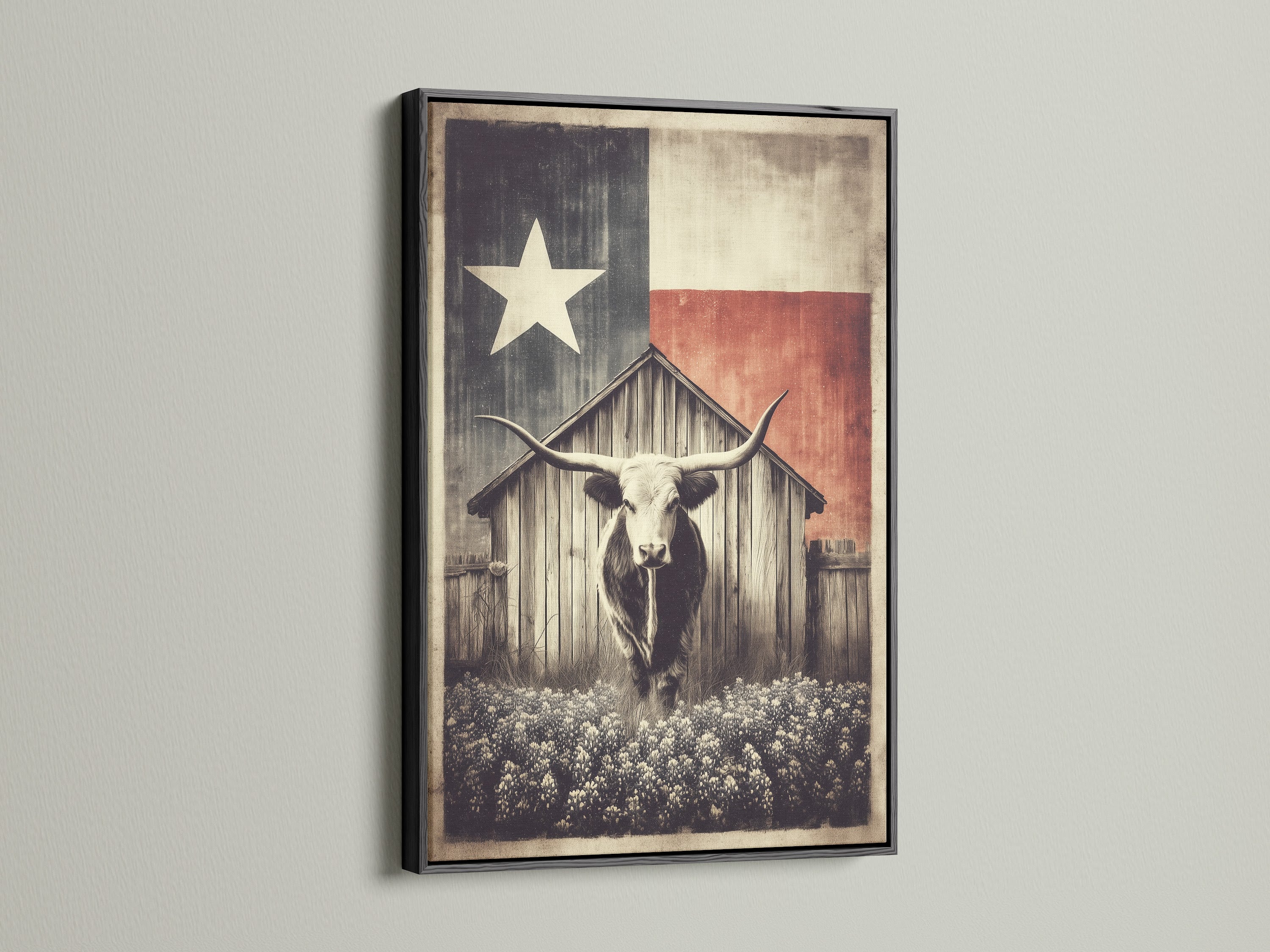 Texas Longhorn art print in a black frame. The artwork features a longhorn in front of a wooden barn. A Texas flag is behind the barn. This rustic farm wall art brings vintage western decor to any space. The black frame adds sophistication.