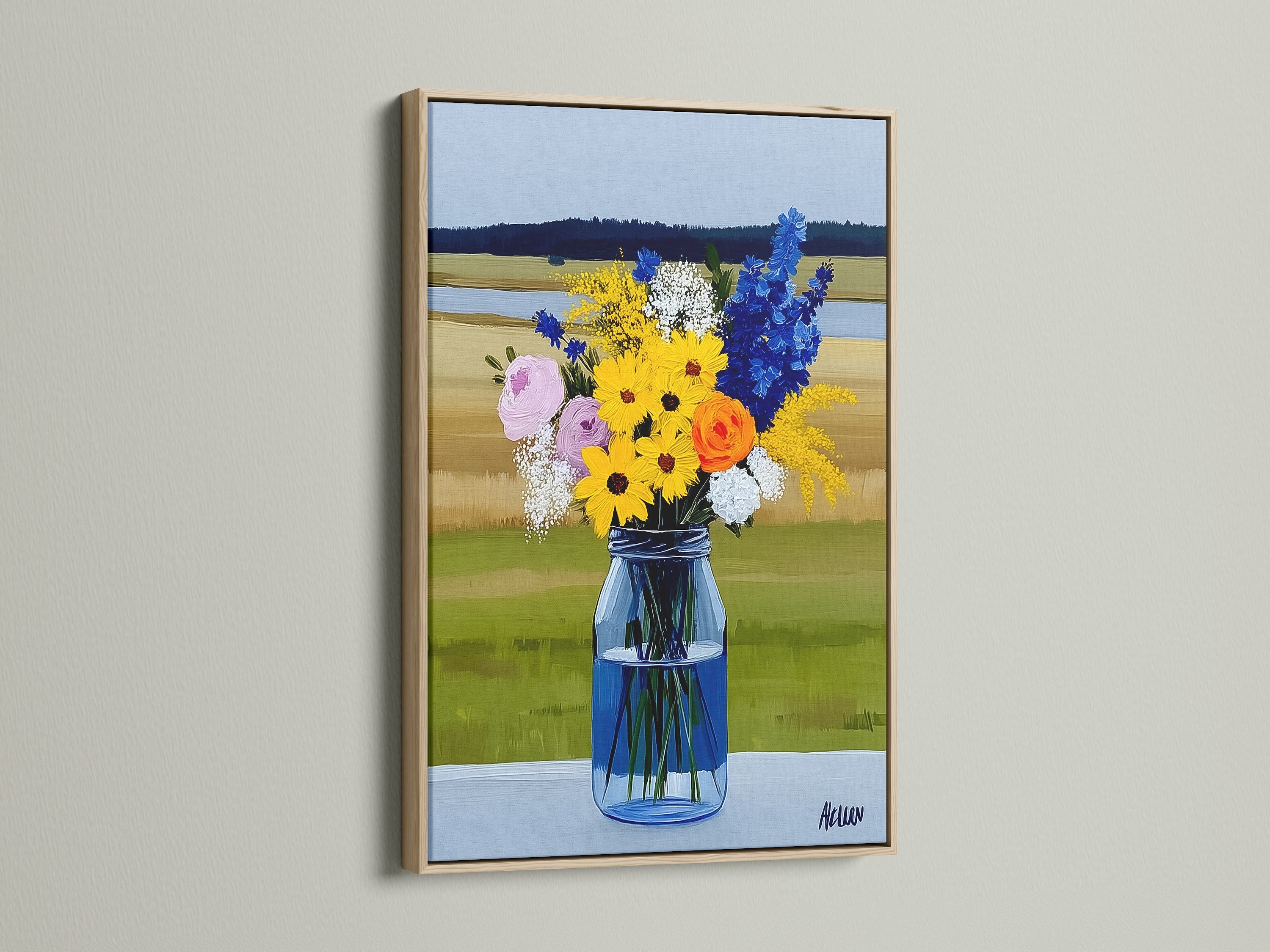 A colorful wildflower bouquet artwork is displayed in an oak frame. The art features a variety of flowers in a blue vase. The art embodies a rustic farmhouse style.