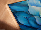 A canvas print in a floating frame is angled to show depth. The blue flower artwork appears to float. This modern wall art adds a unique dimension to any space. The floating frame enhances the contemporary feel. It is a great choice for those seeking sophisticated wall decor.