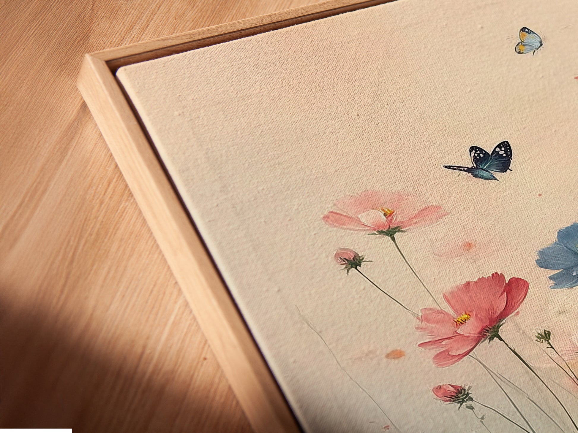 Close-up of a Floral Meadow canvas print in a floating frame. This botanical artwork adds a modern touch to any space. The fine art print enhances bedroom wall decor. Perfect for creating a bohemian or eclectic style. The art features pink and blue tones.