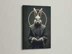 The rabbit monk art print is displayed in a sleek black frame. The dark frame enhances the gothic elements of the artwork. It is a striking piece of religious art for a modern space. This animal portrait is perfect for gothic home decor.
