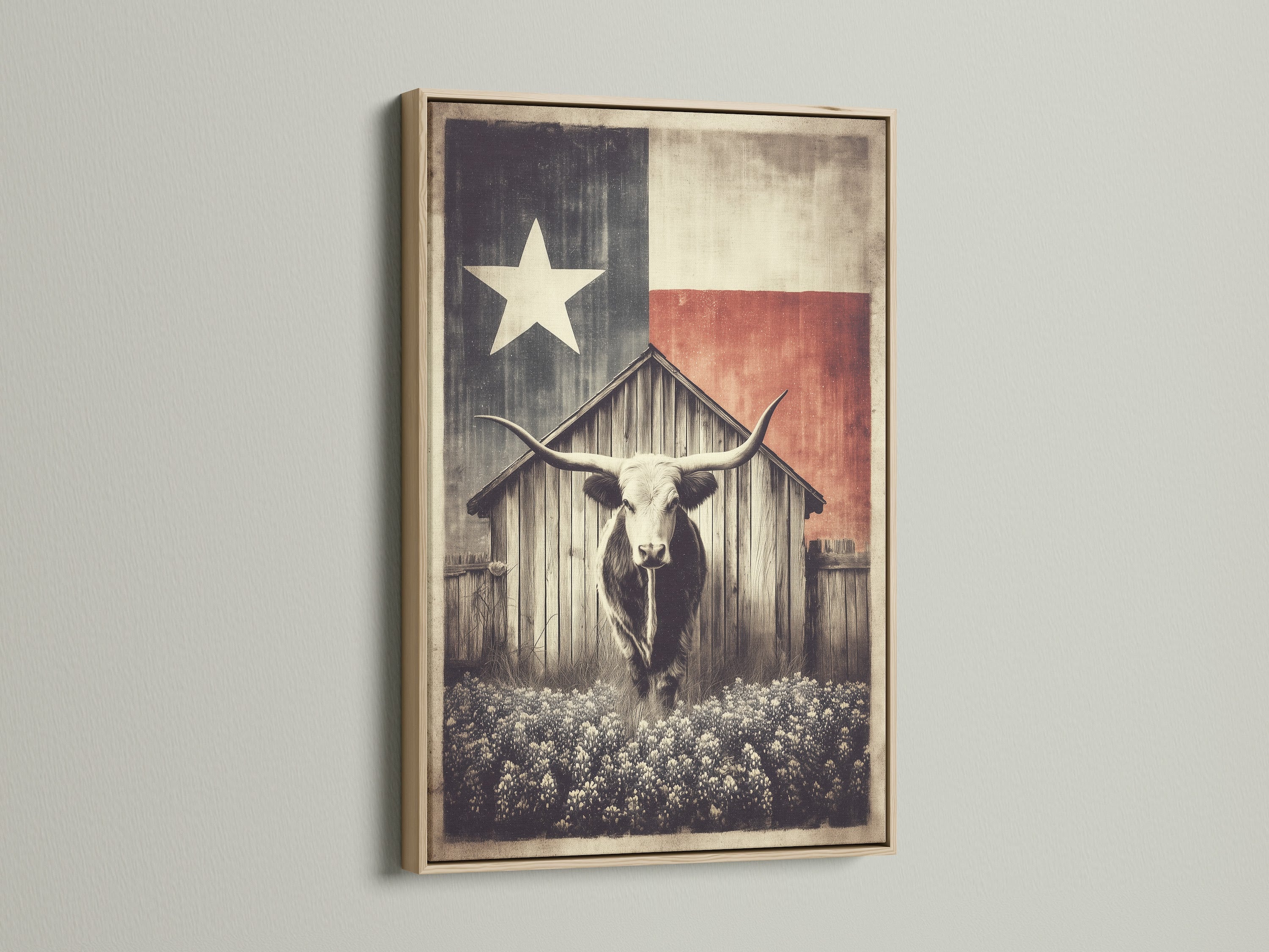 Texas Longhorn art print in an oak frame. The artwork features a longhorn in front of a wooden barn. A Texas flag is behind the barn. This rustic farm wall art brings vintage western decor to any home. The oak frame adds a natural touch.