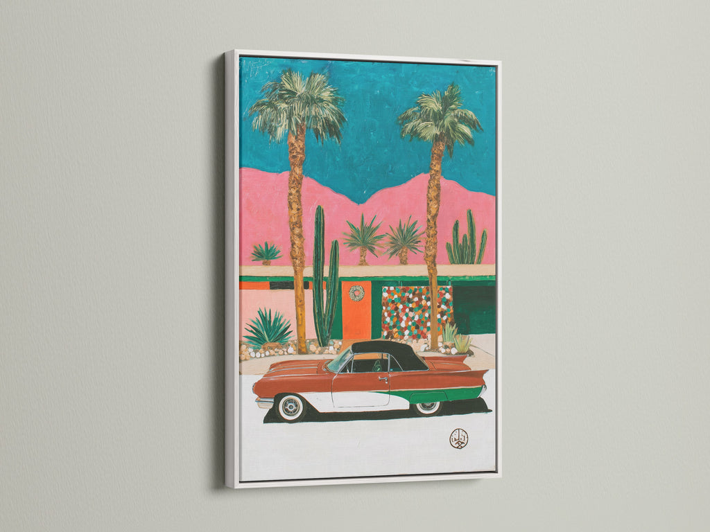 Retro Palm Springs wall art displayed in a white frame. The artwork captures a mid-century modern desert scene. Palm trees and a vintage car create a nostalgic vibe. This print is ideal for brightening up your living room or office with a touch of retro charm.