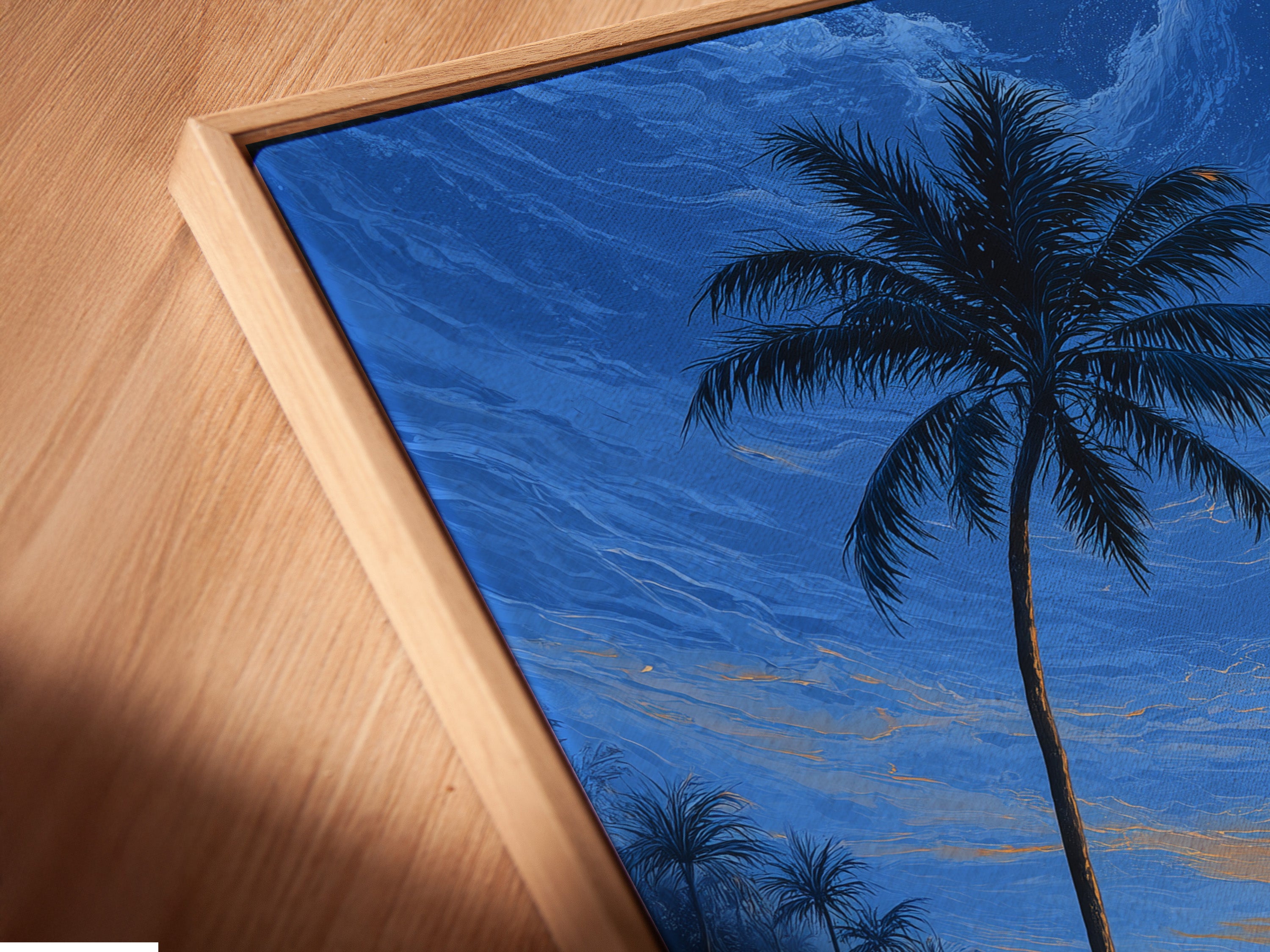 A close-up angled view of a canvas print in a floating frame. The tropical beach art shows a palm tree at sunset. Ocean waves enhance this coastal wall decor. The floating frame adds depth and style to this ready to hang artwork.