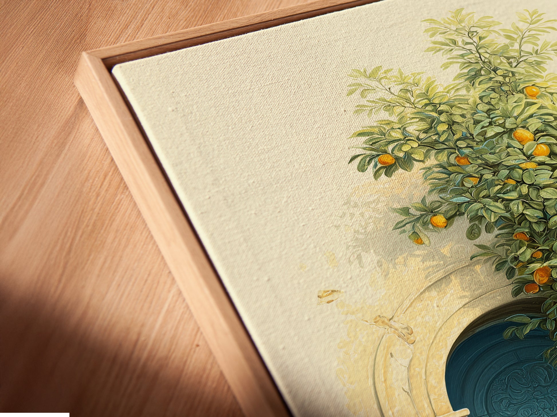 A close-up angled view of a canvas print in a floating frame. The artwork features an Italian Lemon Tree a Tuscan doorway and Mediterranean decor. The azure door and terracotta pots add charm. Perfect for kitchen wall art in vintage coastal or rustic styles