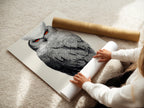 A woman carefully rolling a fine art poster paper. Preparing owl artwork for your space. This dotted wildlife canvas transforms any room. Modern animal art is ready to be displayed. Perfect for art lovers.
