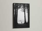 Black and white art print of a beach and forest. The artwork is presented in a sleek black frame. A black frame adds sophistication to any art piece. It creates a striking contrast with the wall. Consider a black frame for your next art purchase.