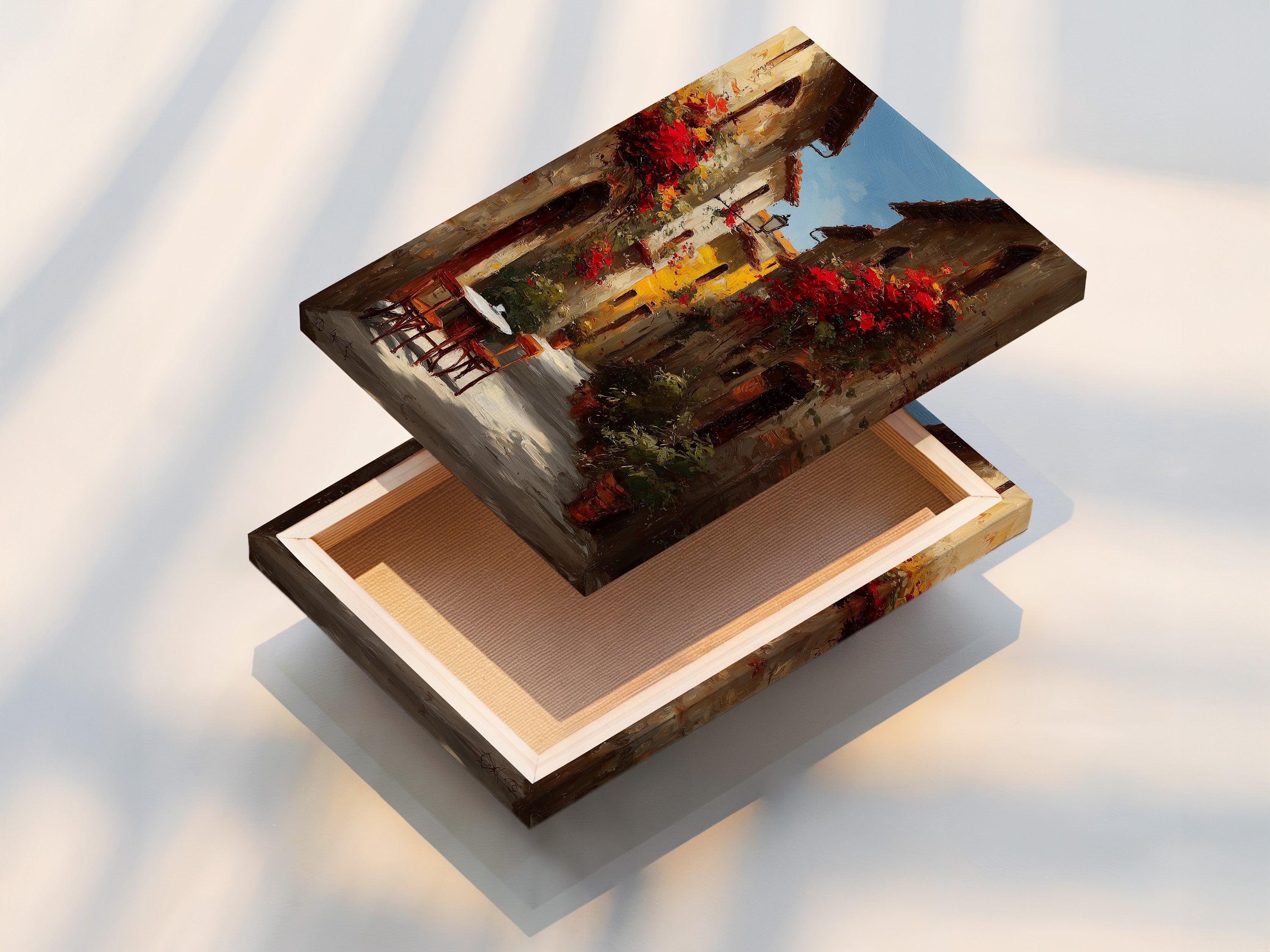 Stretched canvas print of an Italian street scene with red flowers. The canvas is stretched tightly over a wooden frame. The artwork looks vibrant and detailed. This creates a ready-to-hang piece of art. The light highlights the texture of the canvas.