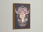 Artwork of a floral bull skull in a gold frame. The art print features a skull adorned with colorful roses. This artwork is framed in an elegant gold frame. The gold frame adds a touch of luxury. Perfect wall art for any space.