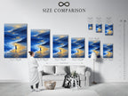 A size comparison chart is displayed in an interior setting. It shows various sizes of the Ocean Reflection artwork. See how the blue and gold abstract seascape print fits in different spaces. Visualize the perfect size for your coastal wall decor.