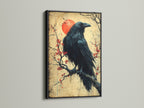Raven Canvas Print with a Black Frame. The bird on a cherry blossom branch is displayed. This black bird art is a unique gothic print. It is ideal for dark academia or eclectic styles. Perfect as office art.