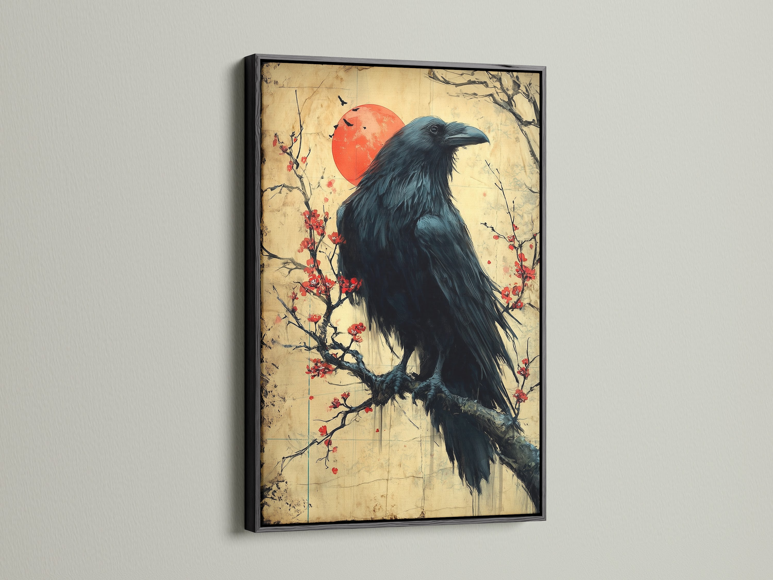 Raven Canvas Print with a Black Frame. The bird on a cherry blossom branch is displayed. This black bird art is a unique gothic print. It is ideal for dark academia or eclectic styles. Perfect as office art.