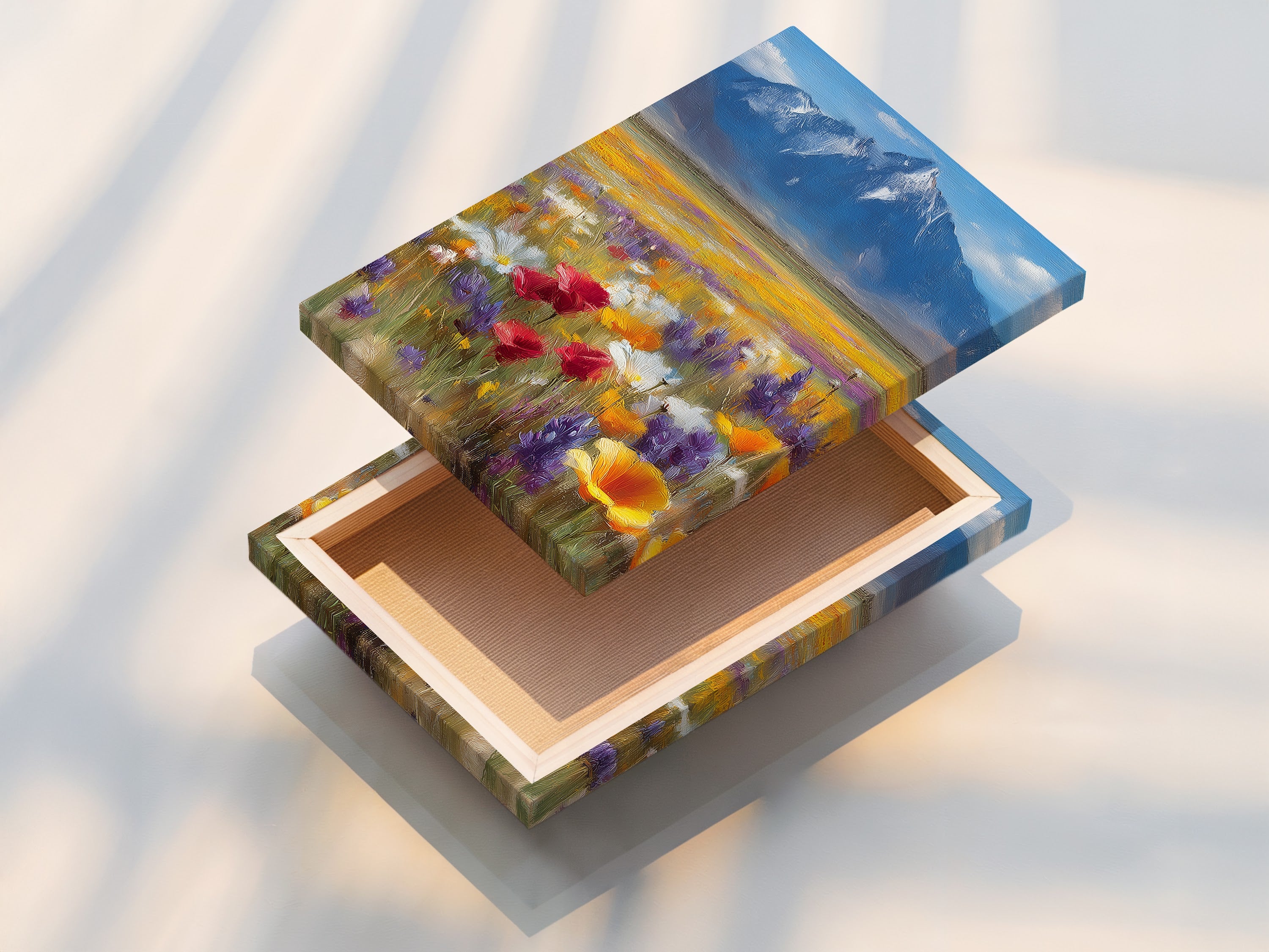 A stretched canvas print featuring a wildflower meadow. The artwork displays a beautiful mountain landscape. This stretched canvas brings a gallery-quality look to your walls. The colorful poppy field art is ready to hang and enjoy. Perfect for adding a touch of nature to your home or office. Explore our canvas art collection.