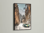 Sports Car Canyon Artwork in a black frame. The art features a green sports car driving through a desert canyon. This automotive print is ideal for man cave decor. A sleek addition to any modern space from garages to showrooms.